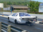 White Dodge Avenger Drag Car Launching